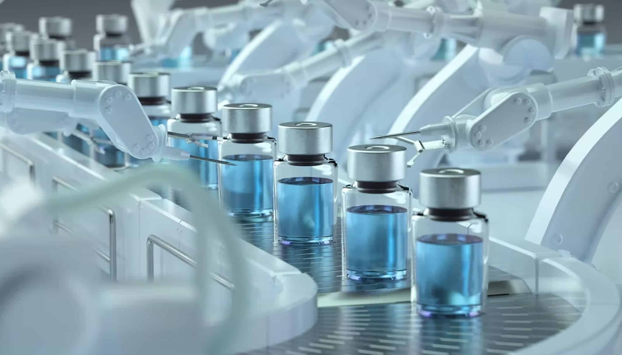 Vials of blue liquid moving through an automated capping line.