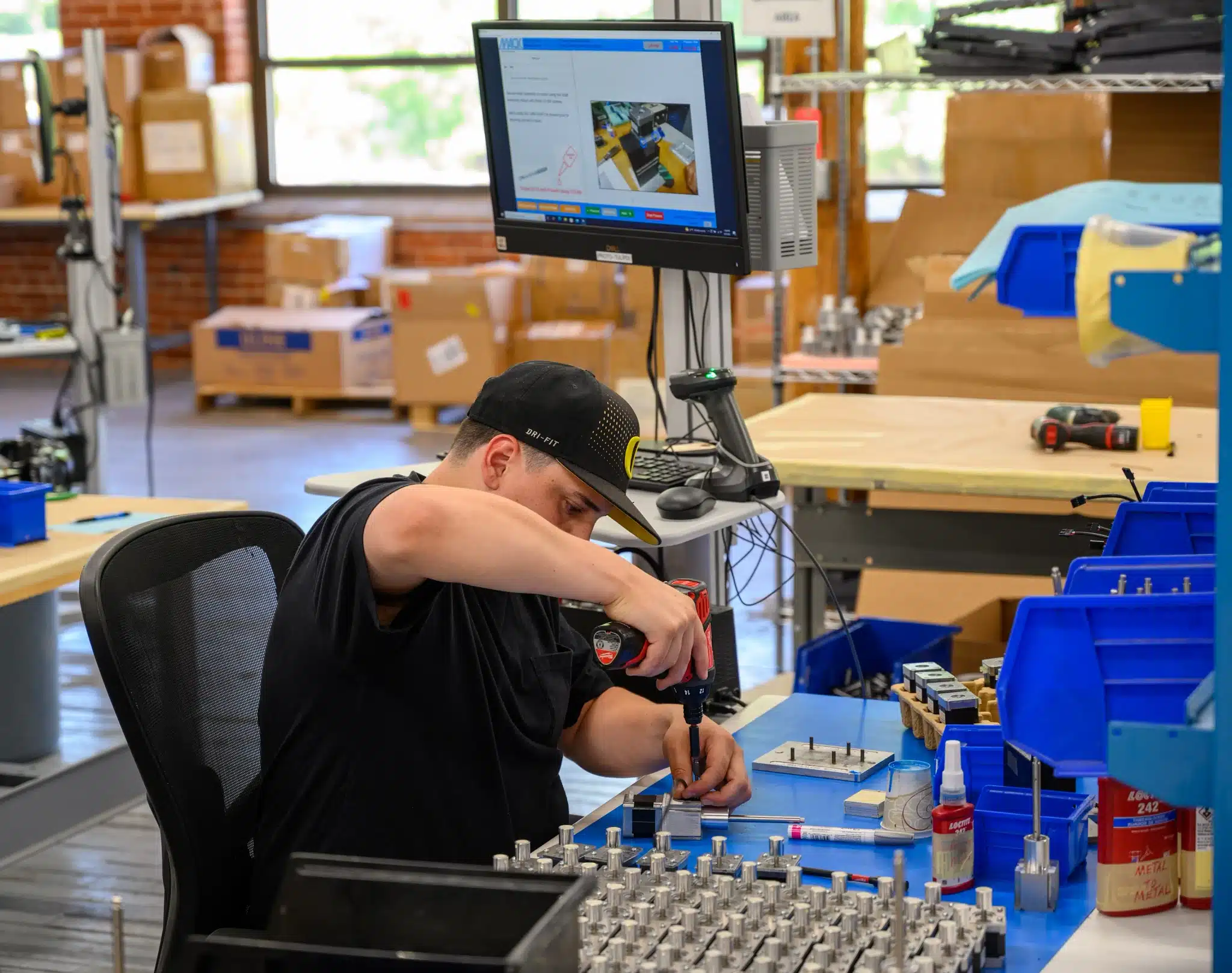 CUST-Mack-Molding-worker-drilling-on-workbench
